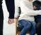 Clenched fist in foreground as parent comforts child on couch, highlighting divorce conflict risk inside