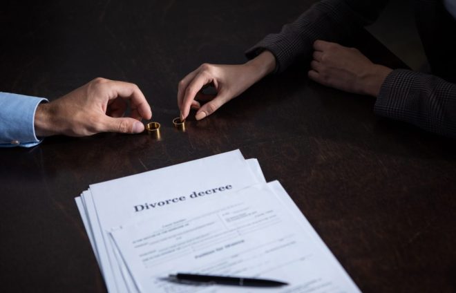 partial-view-of-couple-at-table-with-divorce-docum-2023-11-27-04-51-13-utc