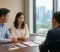 A couple sits across from a divorce lawyer in a modern office while reviewing medical and family law documents related to IVF and surrogacy issues.