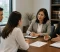 Family Law Meeting Two family lawyers discuss legal documents with a couple during an office consultation